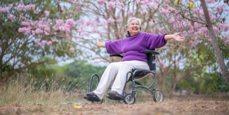 Senior Woman in Wheelchair Enjoying Outdoors of Assisted Living Communities