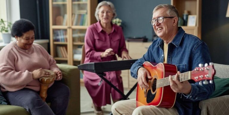 Elderly Residents Playing Guitar and Drums Happily at Memory Care Facility