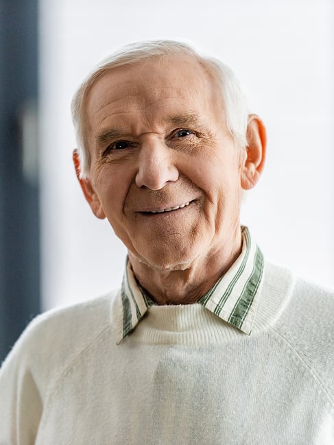 Smiling Elderly Man in Cream Sweater and Collared Shirt Smiling Elderly Man in Cream Sweater and Collared Shirt