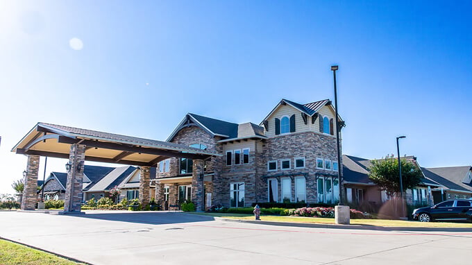 Assisted Living Community Exterior with Covered Drive-Up Entrance Assisted Living Community Exterior with Covered Drive-Up Entrance